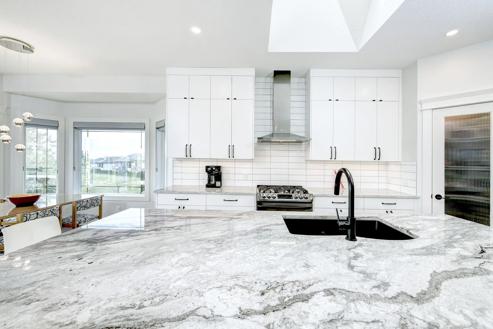 Arbour Lake, Calgary. Range wall with tiled backsplash and a marble island