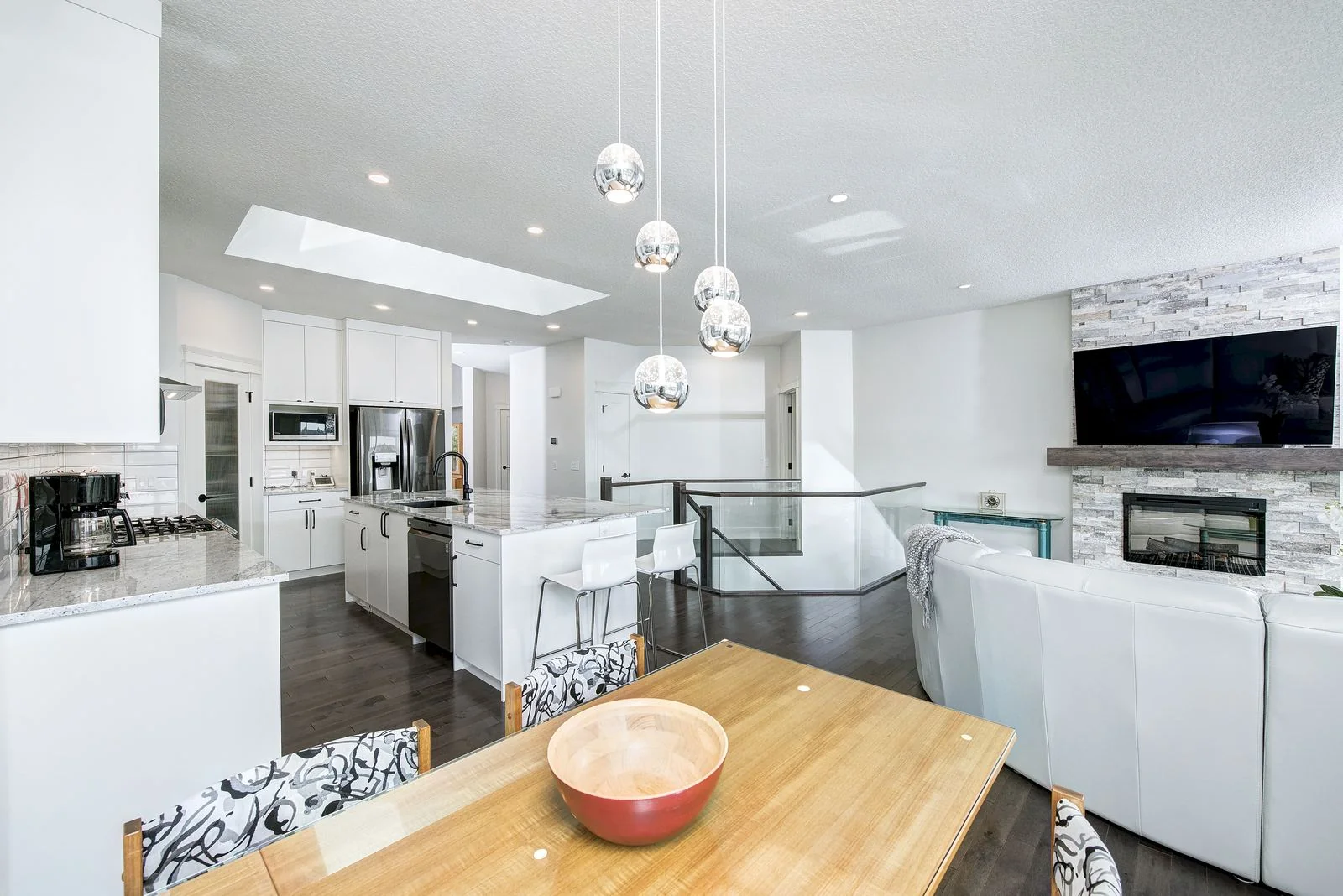 Dining table with the living room and kitchen beyond