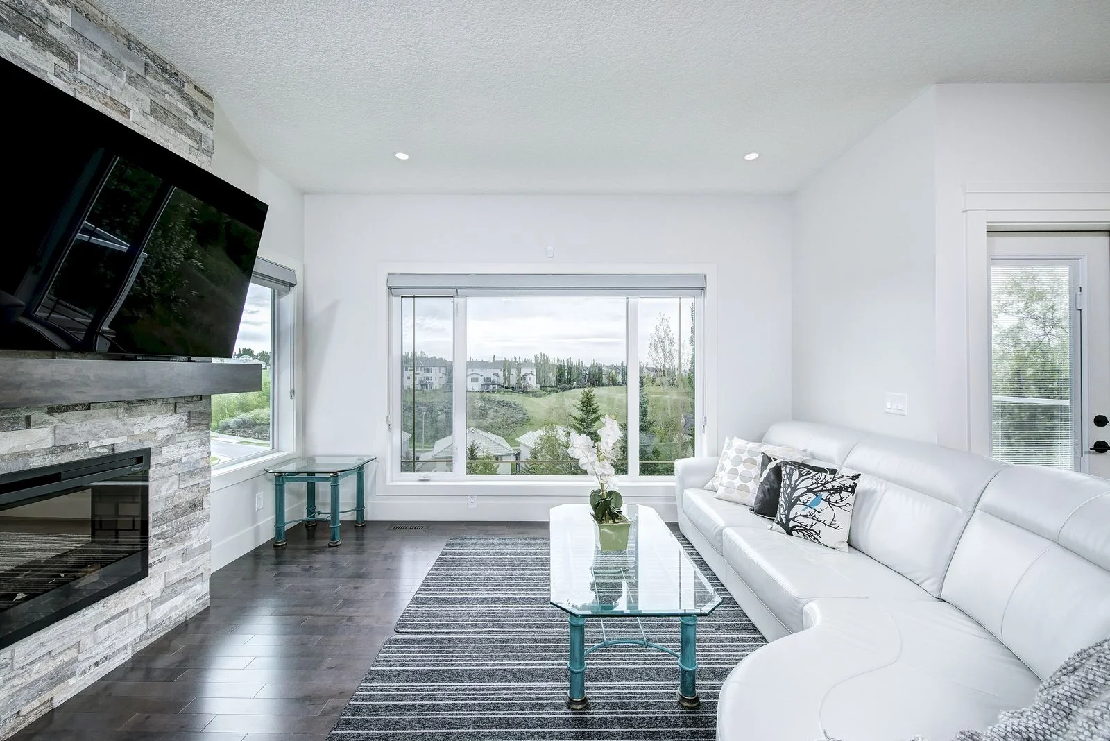 Living room fireplace and sectional facing the view