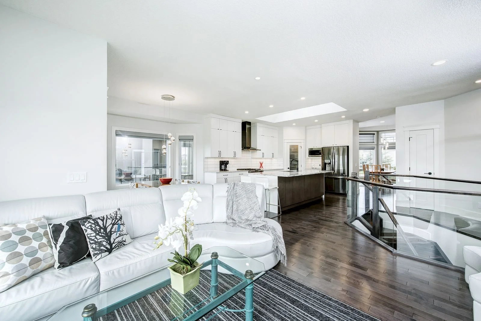 Living room seating with the kitchen beyond