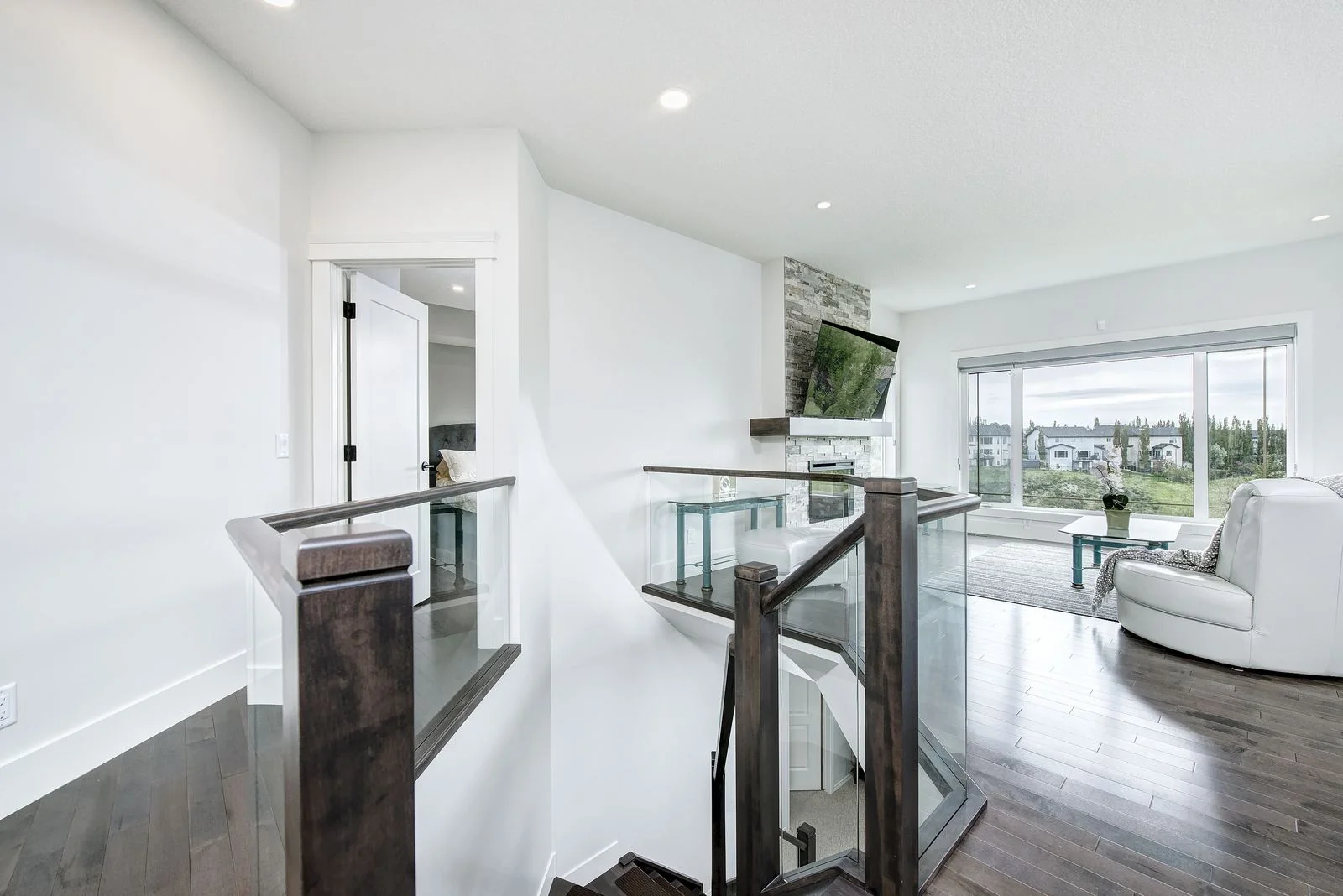 Open stair rail with the living room beyond