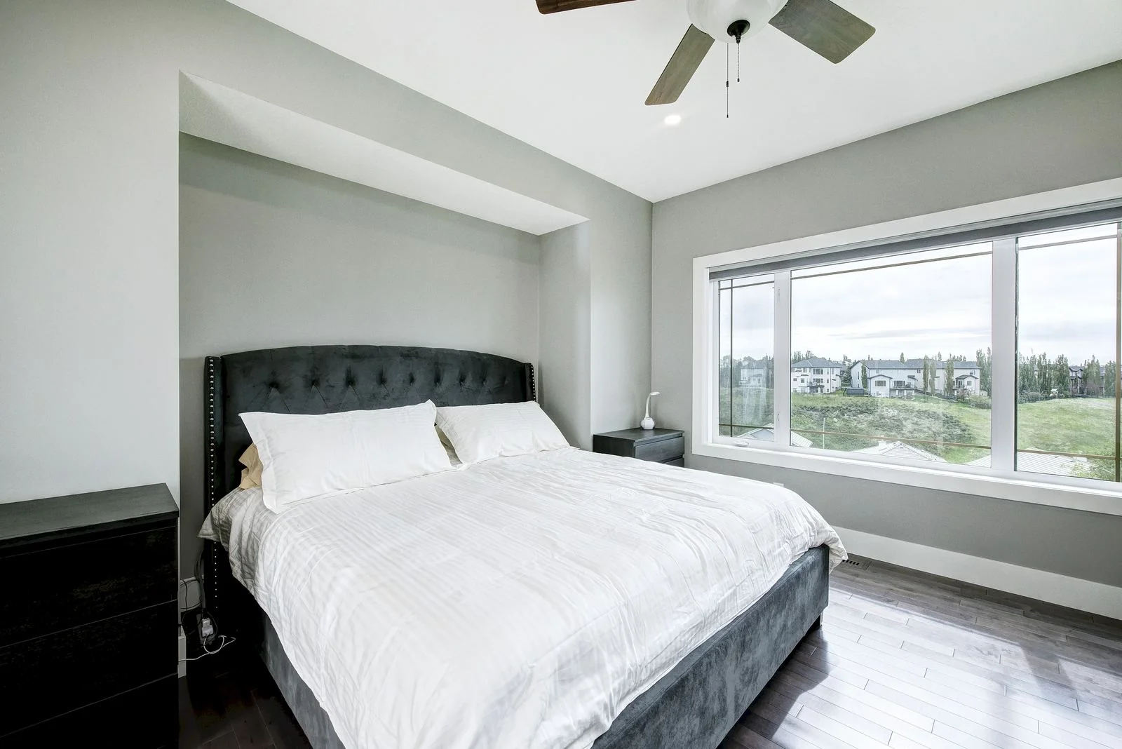Primary bedroom with an upholstered headboard