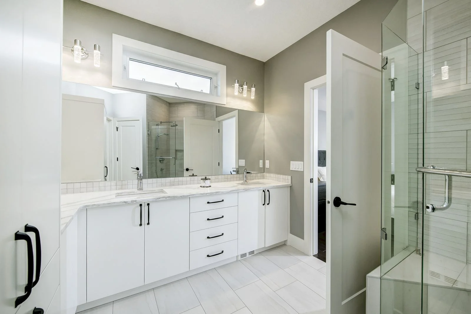 Ensuite vanity beside a glass shower
