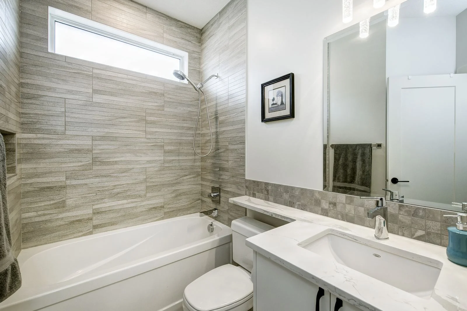Bathroom with a tiled tub surround and vanity