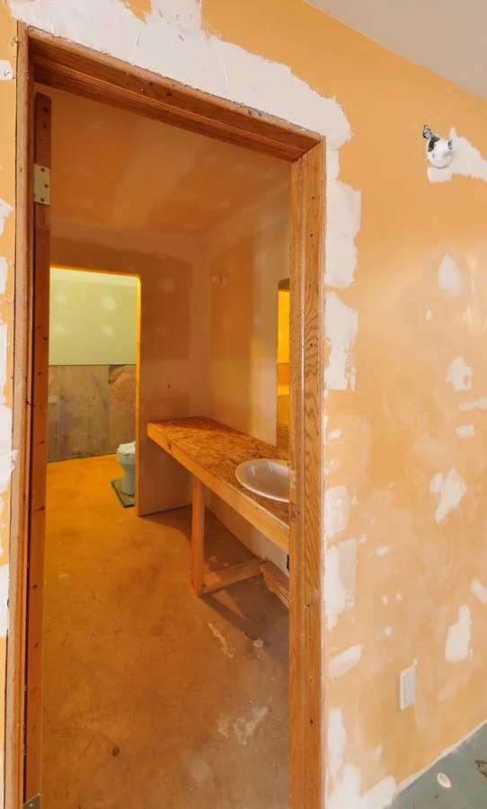 The bathroom part way through demolition with the original vanity still fitted