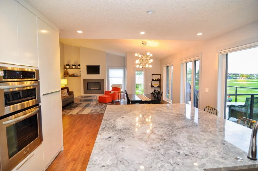 Kitchen island in polished stone looking through to the living area