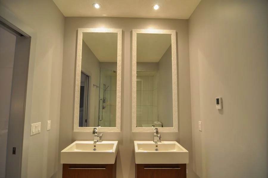 Twin wall hung vanities under matching full length mirrors