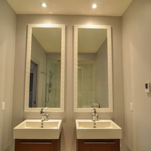 Chestermere, Alberta. Twin wall hung vanities under matching full length mirrors