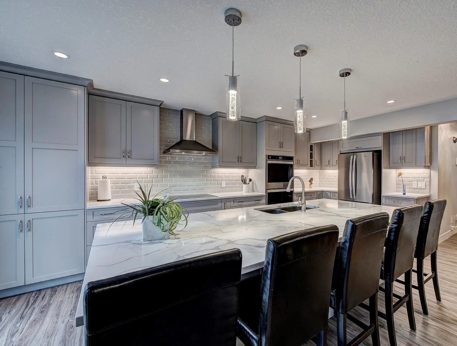 Kitchen island with pendant lights and bar seating