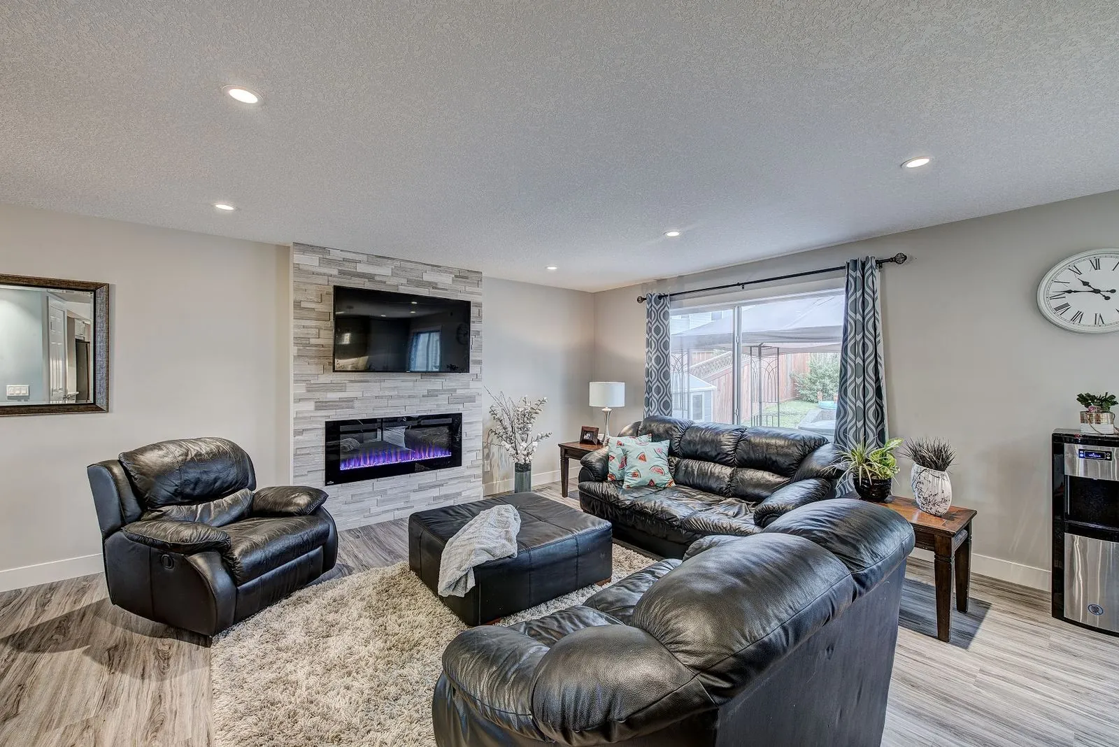 Living room with a stone fireplace and sectional