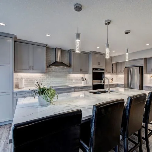 Citadel, Calgary. Kitchen island with pendant lights and bar seating