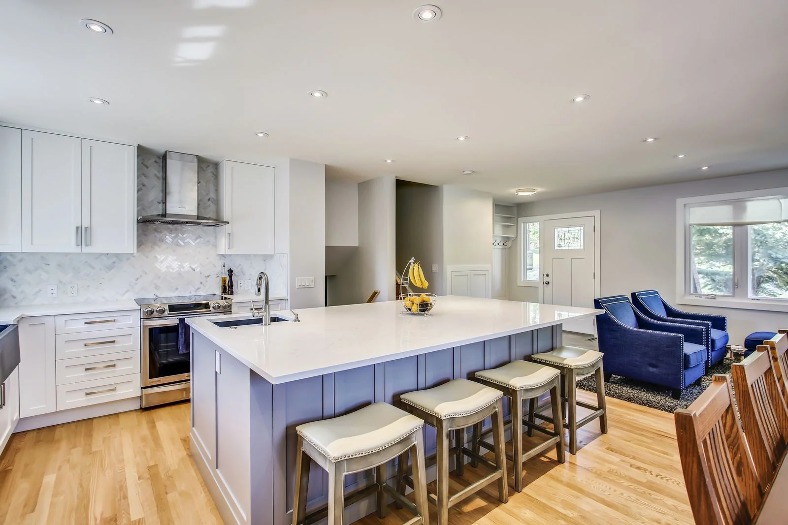 Dalhousie, Calgary. Kitchen island with seating on hardwood flooring