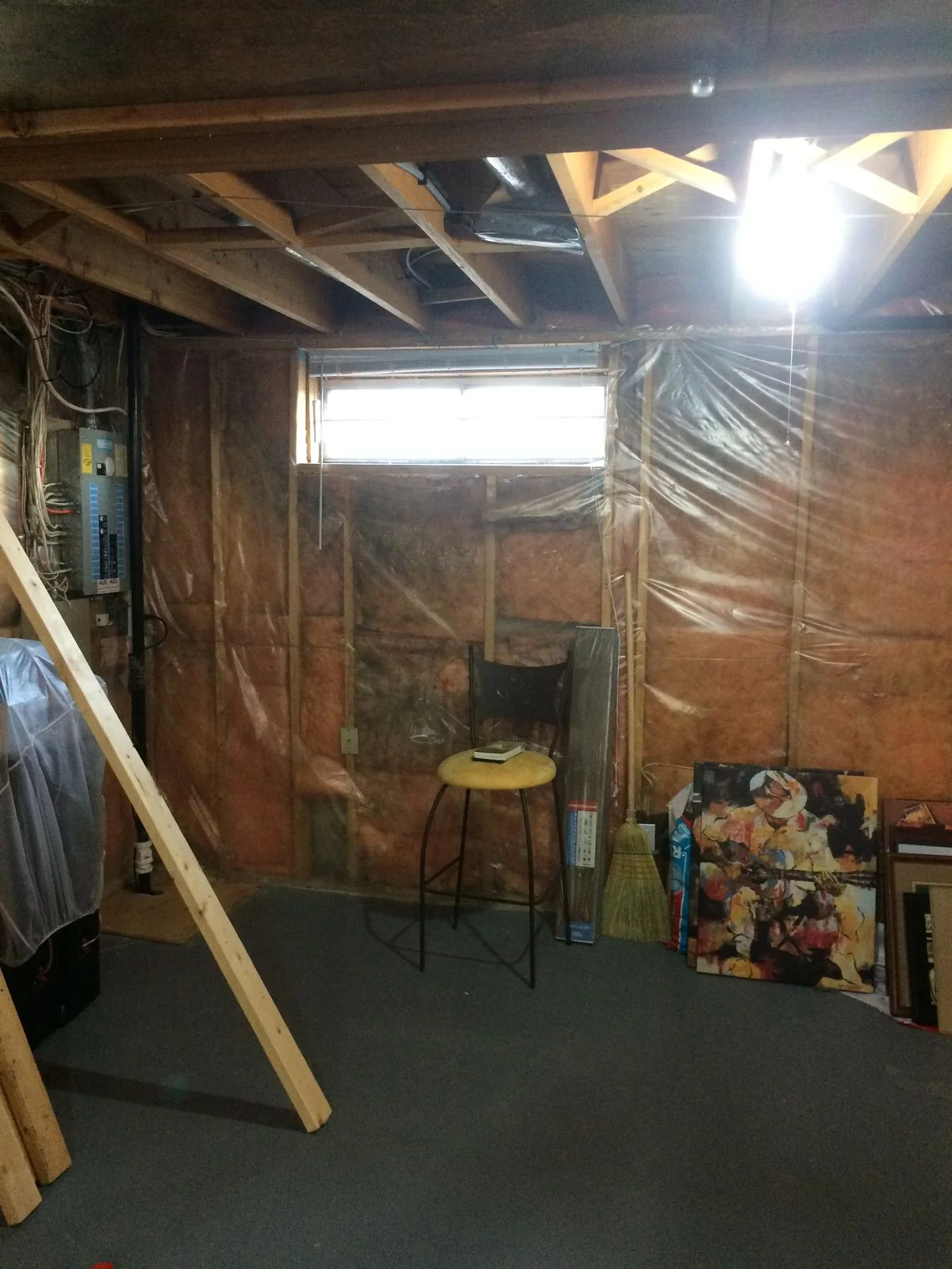 Unfinished basement with framing and vapour barrier