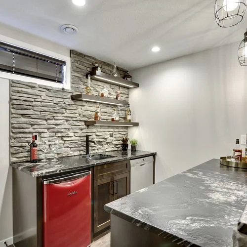Douglas Dale, Calgary. Basement bar with a stone wall and under counter fridge