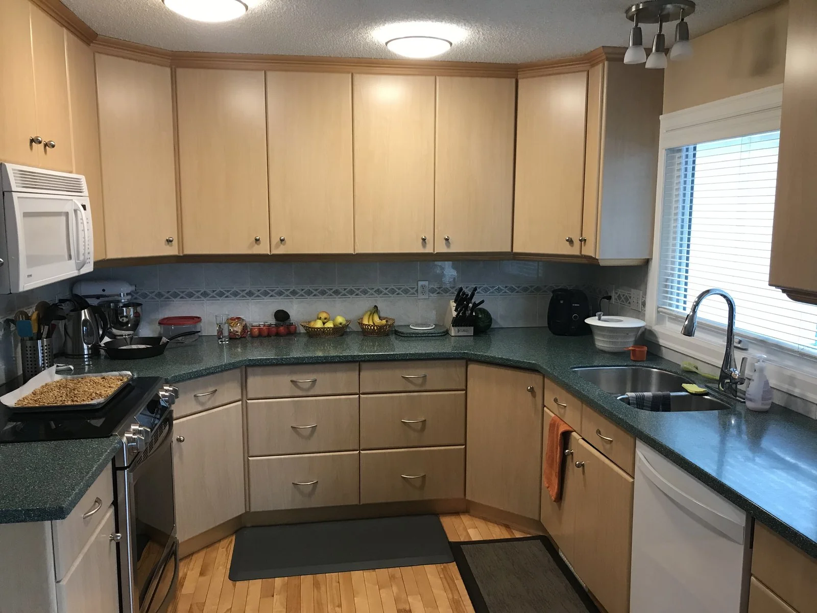 Original kitchen in maple cabinetry with green counters