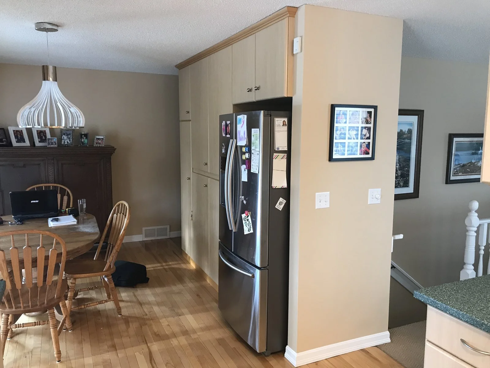Dining area before renovation with the original hutch and pantry wall
