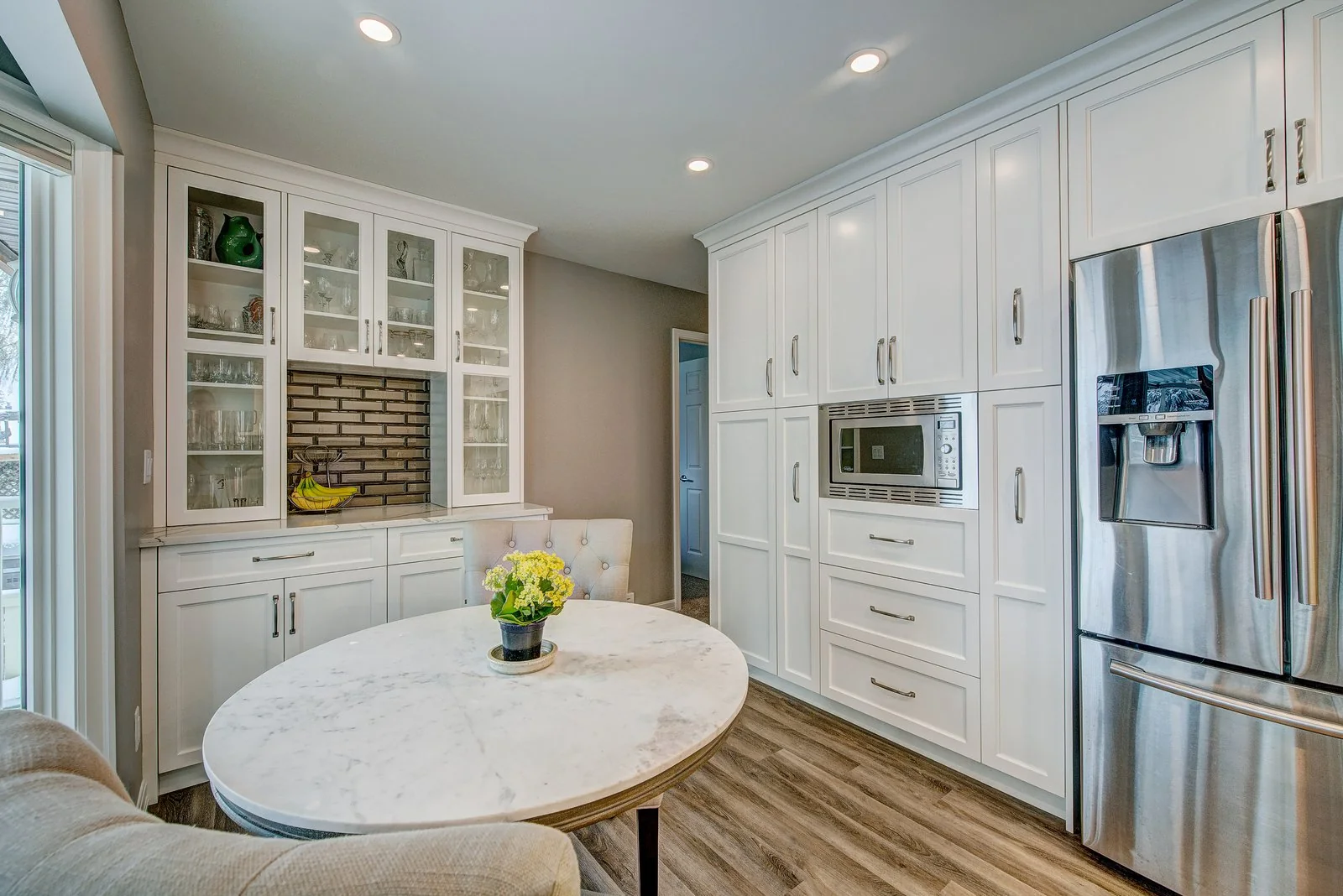 Round dining table with the hutch and the refrigerator wall behind