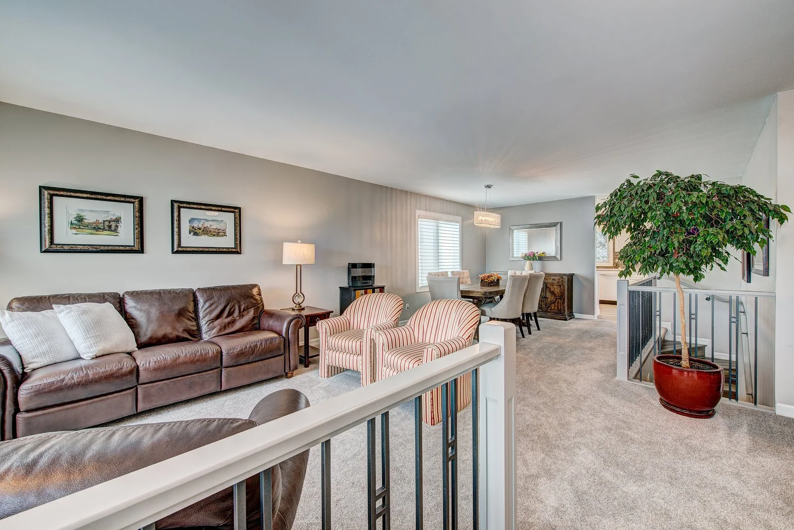 Living room with leather seating and striped occasional chairs