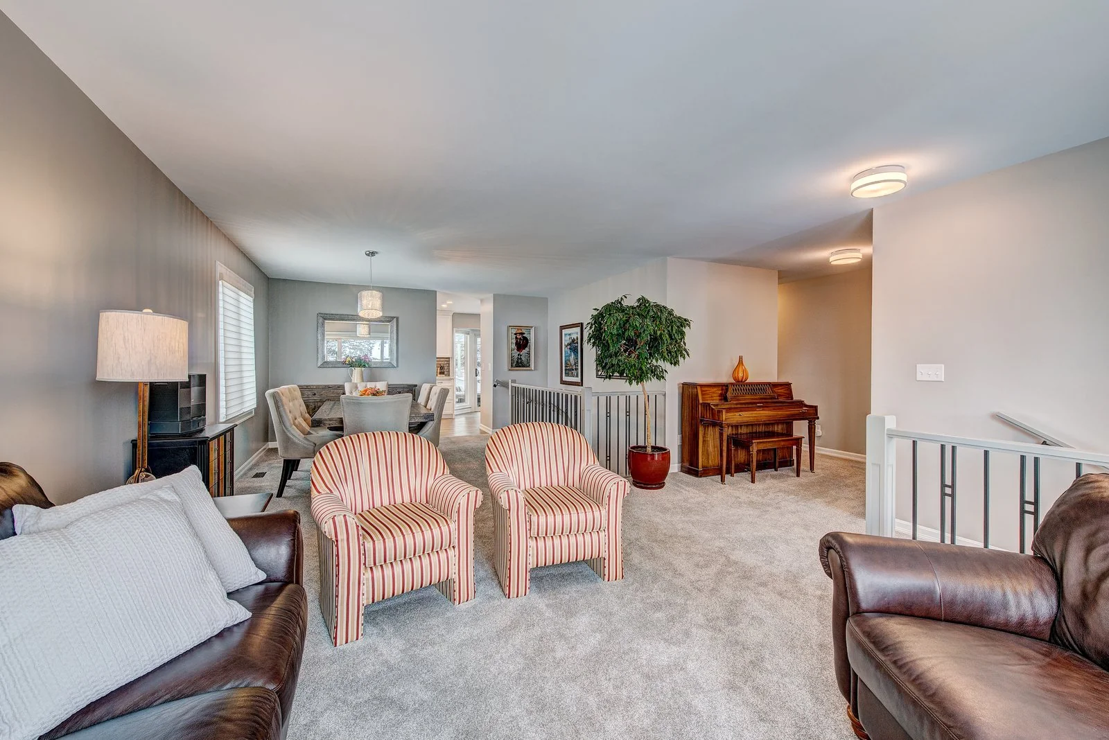 Living room with the piano and the stair railing