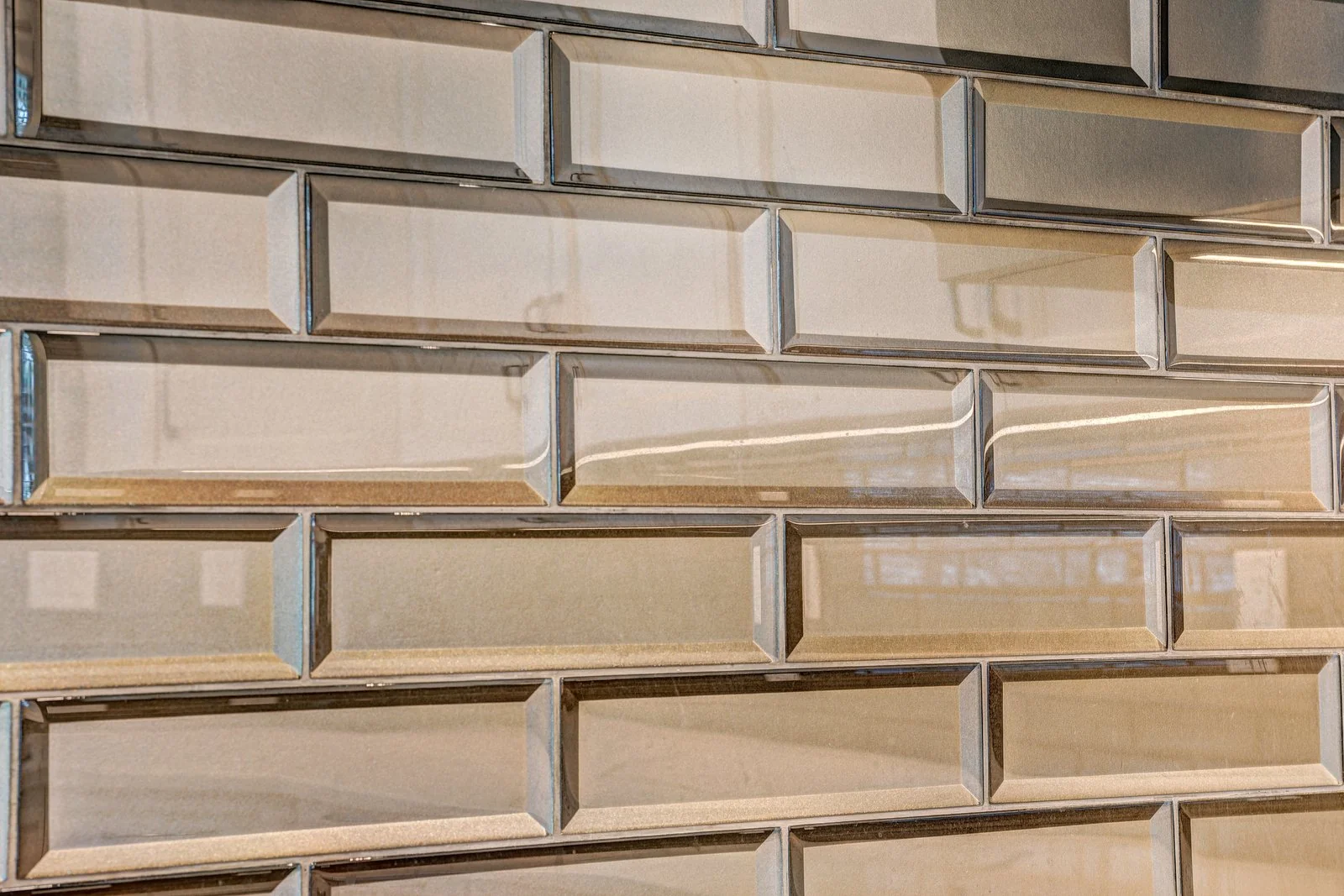 Bronze bevelled glass tile backsplash in close up