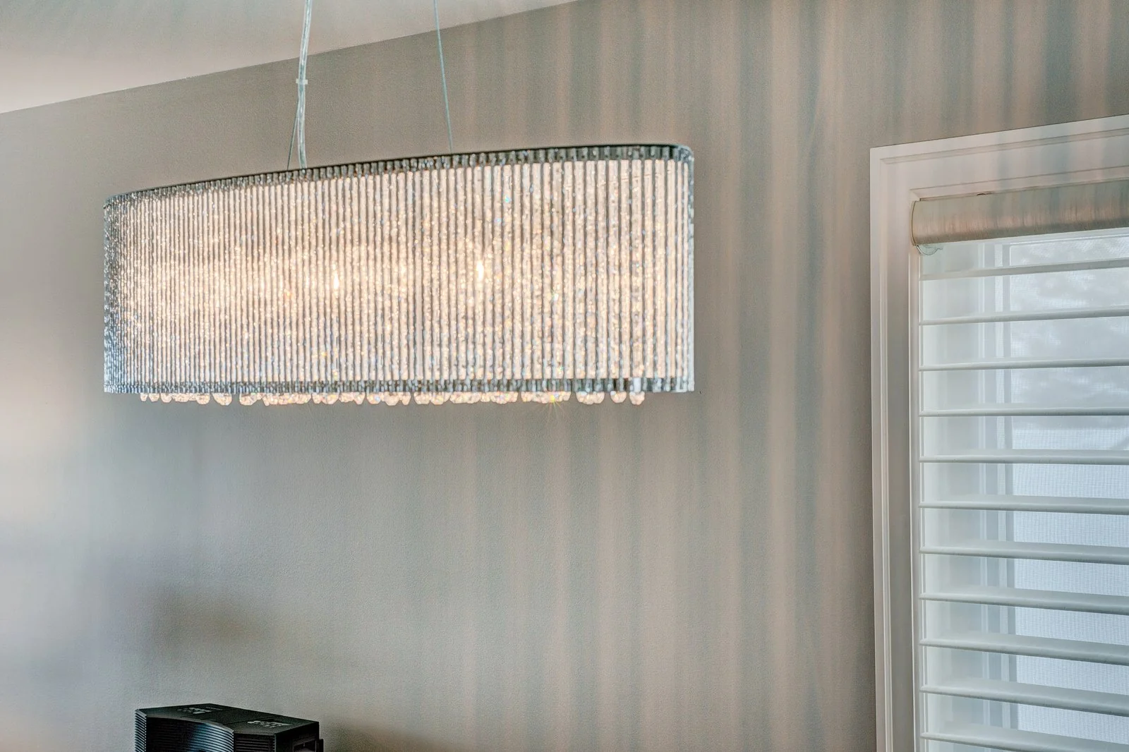 Linear crystal chandelier over the dining table