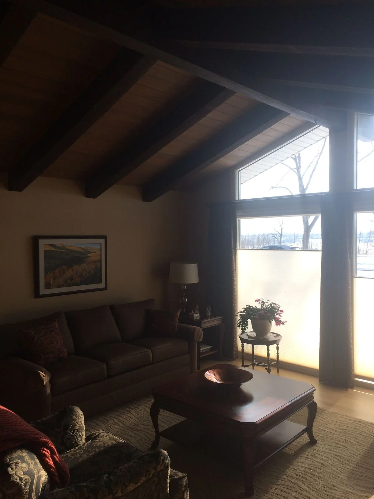 Living room before renovation under a beamed ceiling