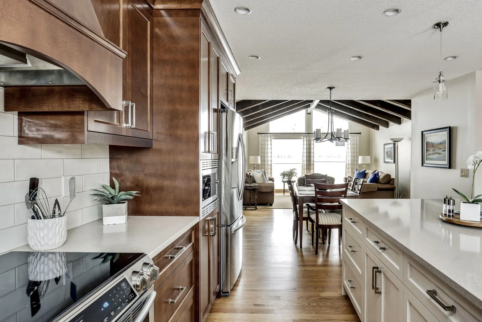 Kitchen with wood cabinetry and a white island