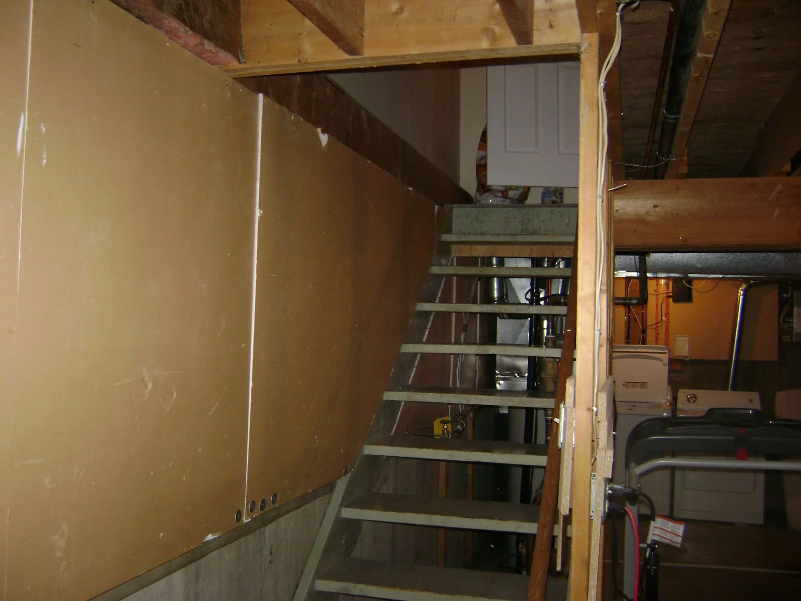 Basement before development, bare stair and utilities