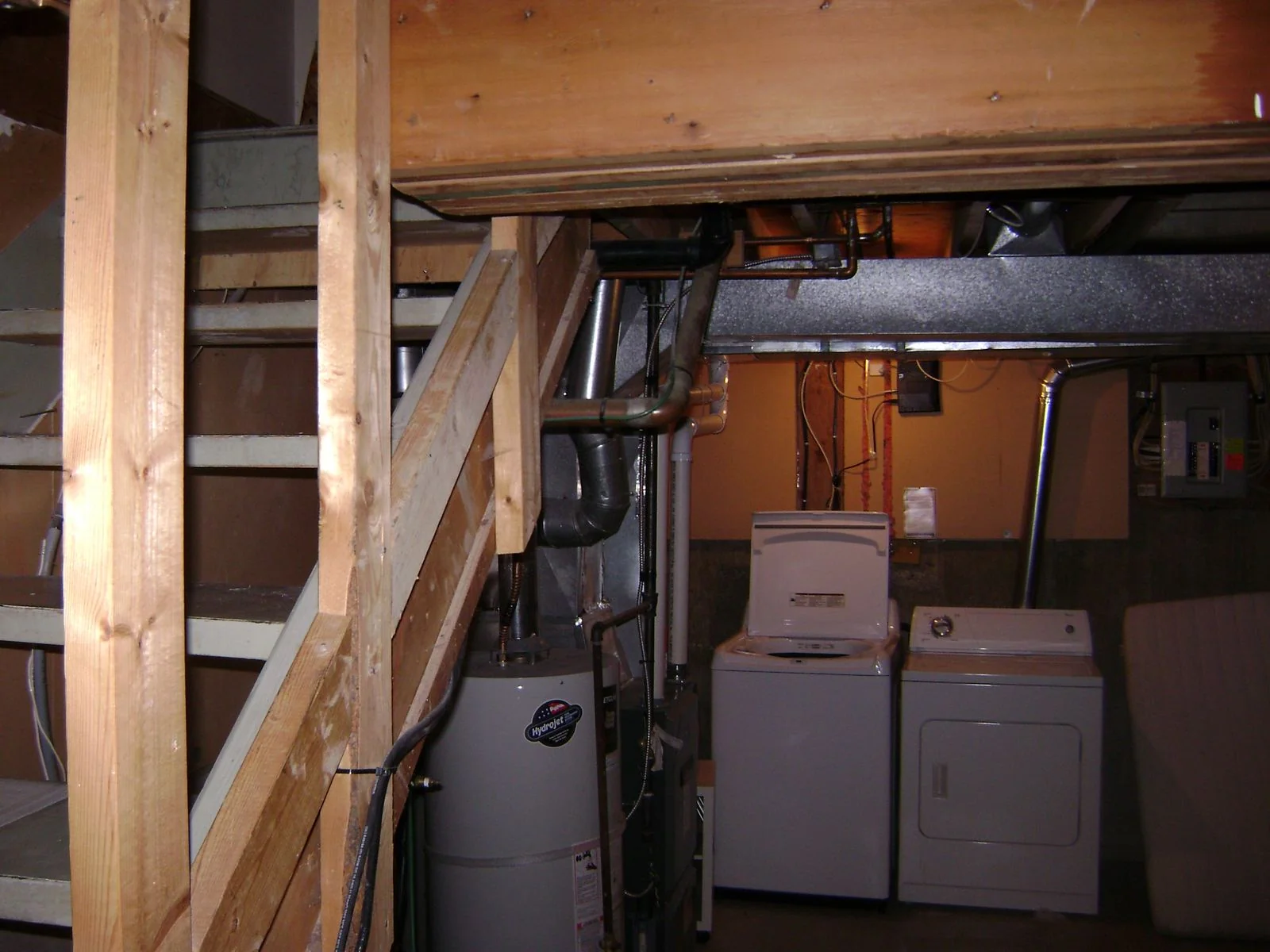 Unfinished basement showing framing and mechanical runs