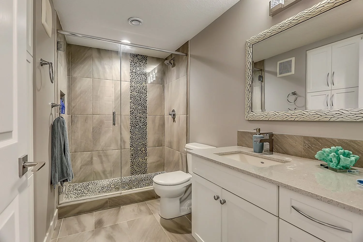 Basement bathroom with a tiled shower and vanity