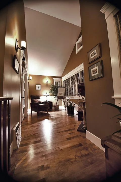 Vaulted hallway in hardwood looking through to the sitting area