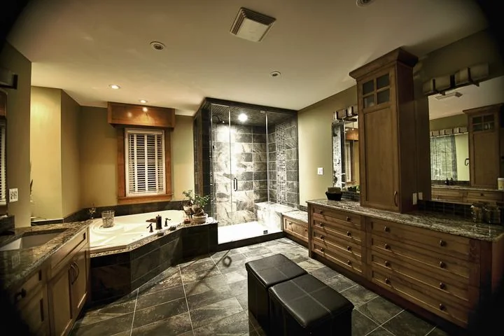 Ensuite with a corner tub and a stone tiled shower beside a long vanity