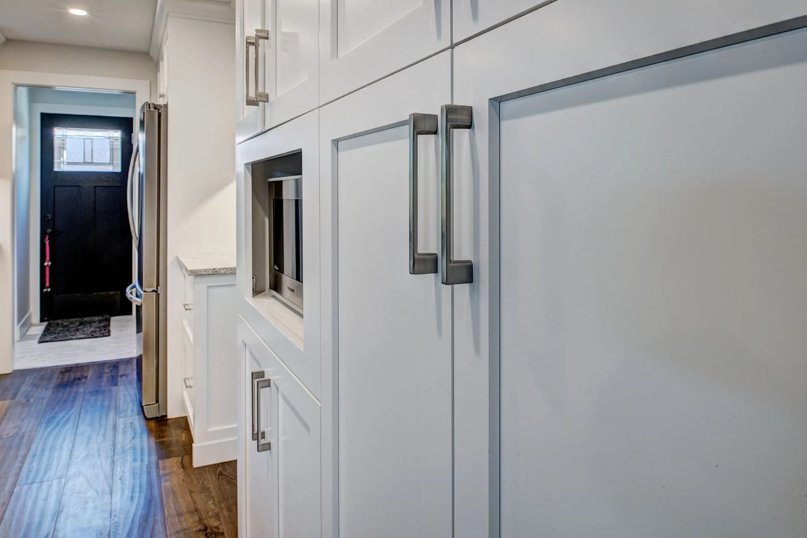 Hallway with tall pantry cabinetry