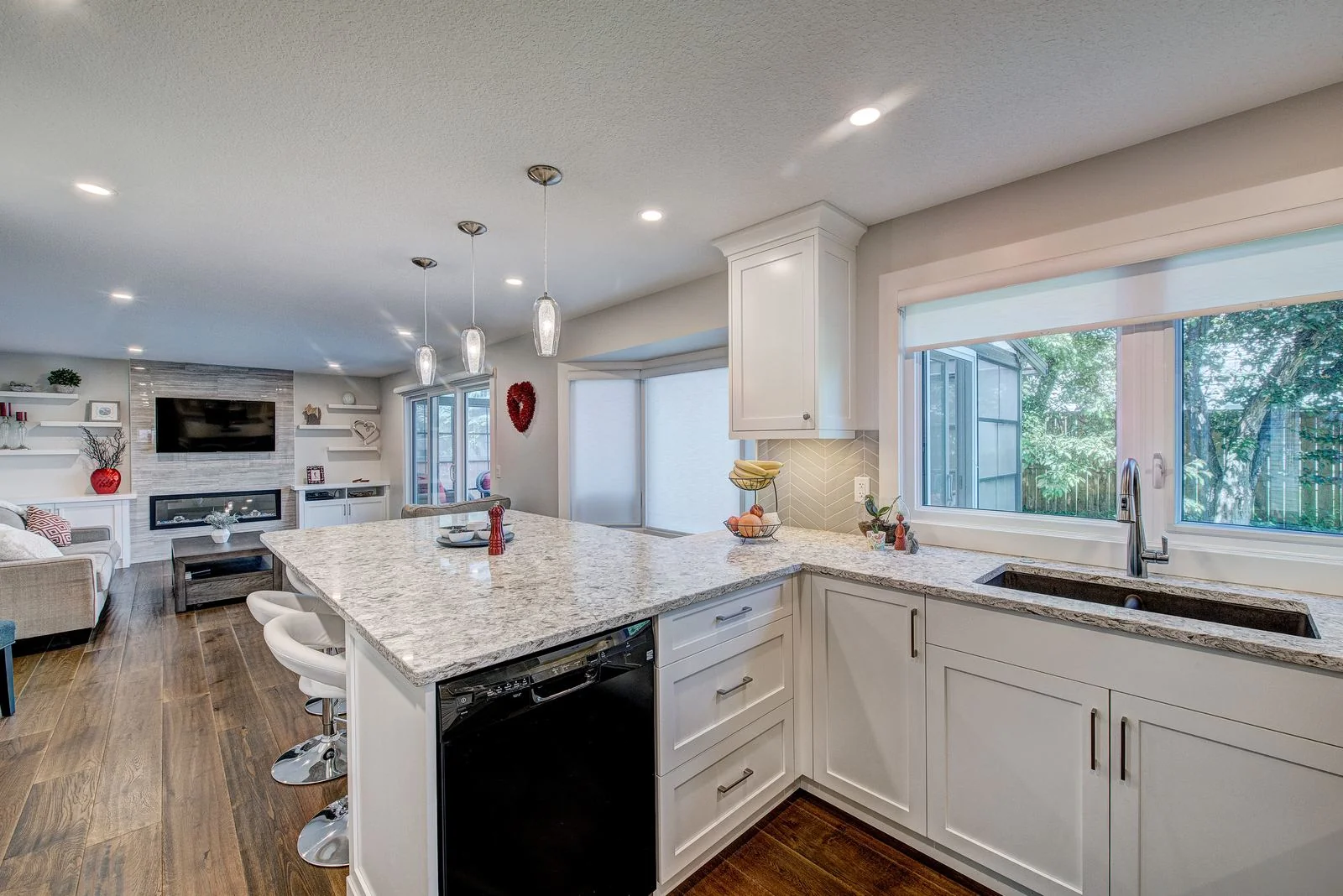 Kitchen island with seating and the open living area beyond