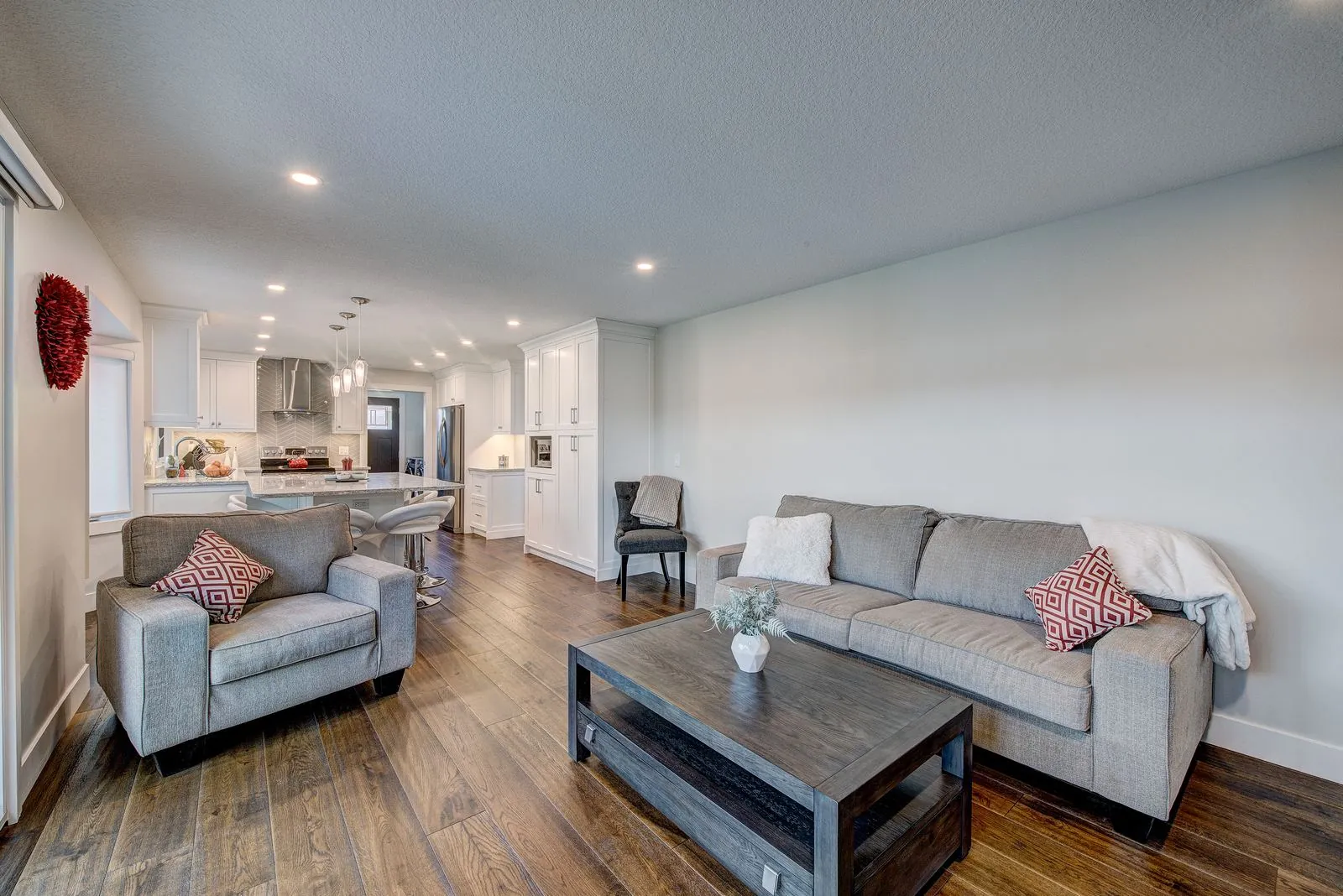 Living area with the open plan kitchen beyond