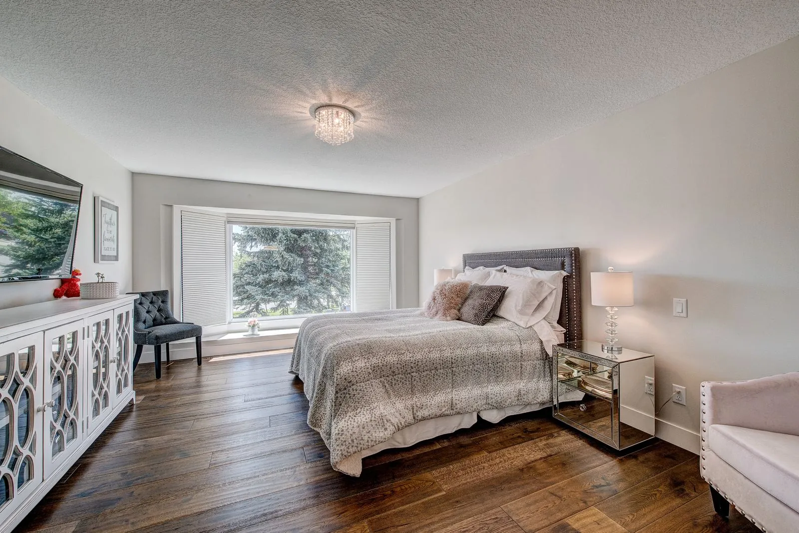 Primary bedroom with a mirrored dresser