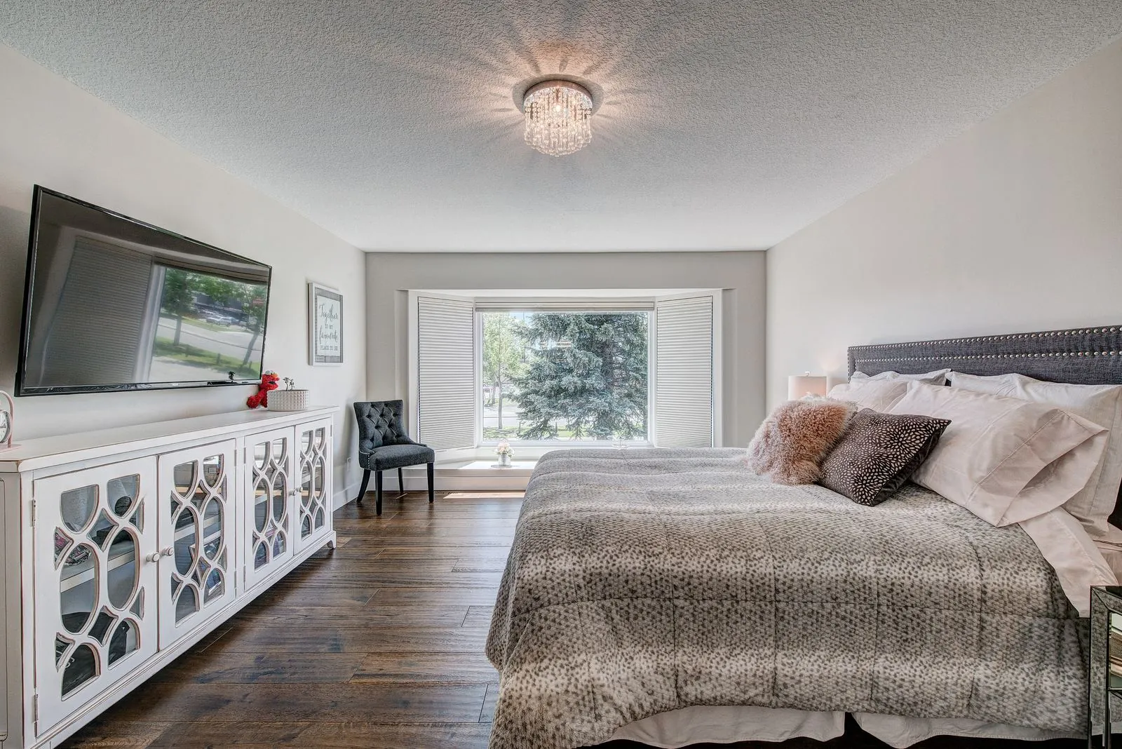 Primary bedroom with a wall mounted television