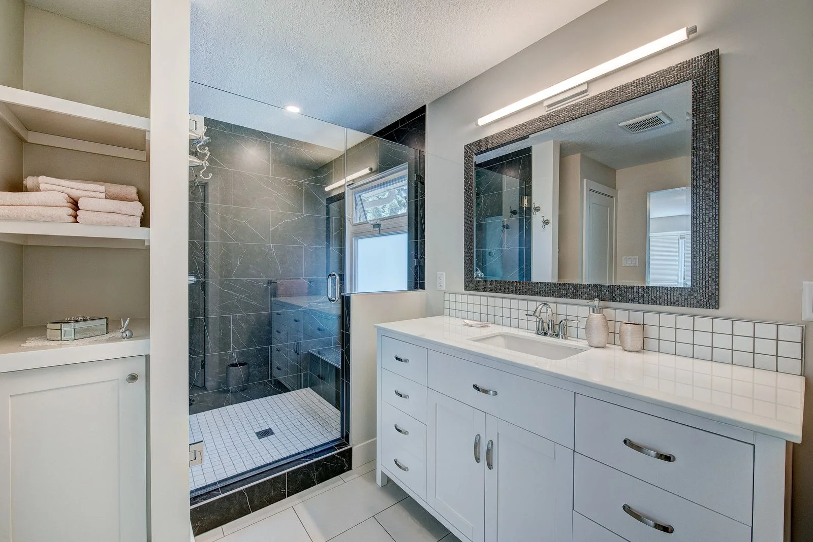 Ensuite vanity with a framed mirror