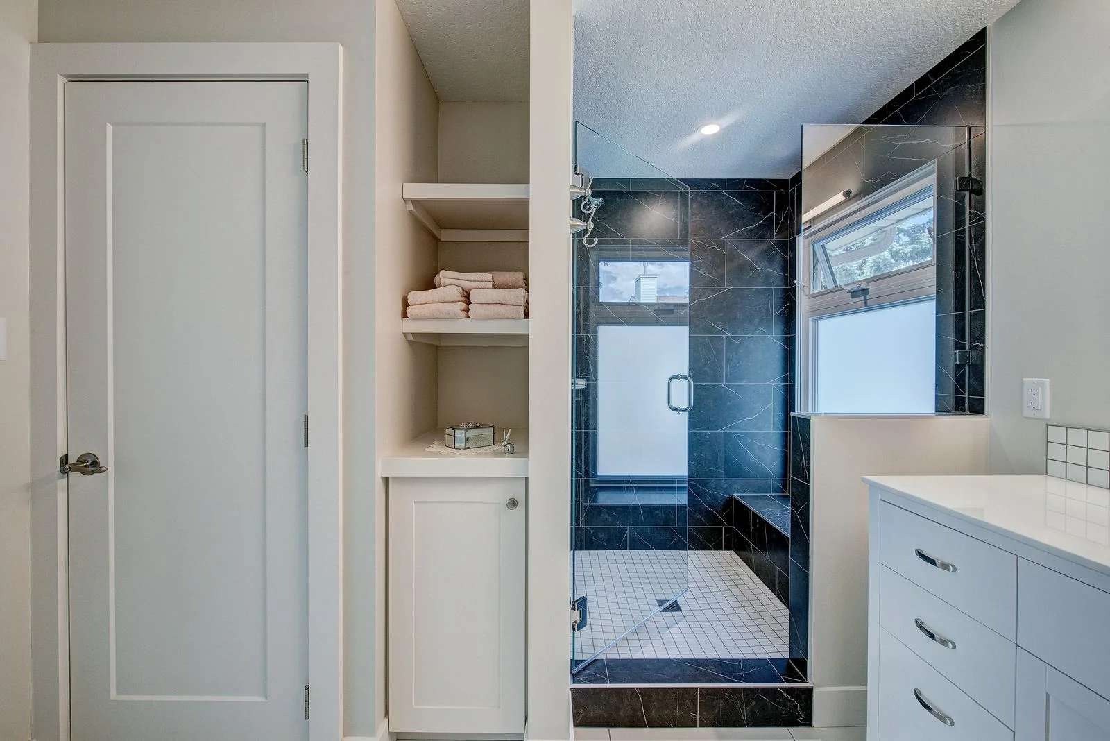 Ensuite with a glass shower and storage niche