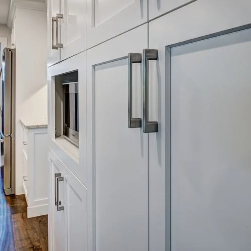 Woodglen, Calgary. Hallway with tall pantry cabinetry