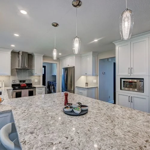 Woodglen, Calgary. Kitchen with a wall oven and pendant lighting