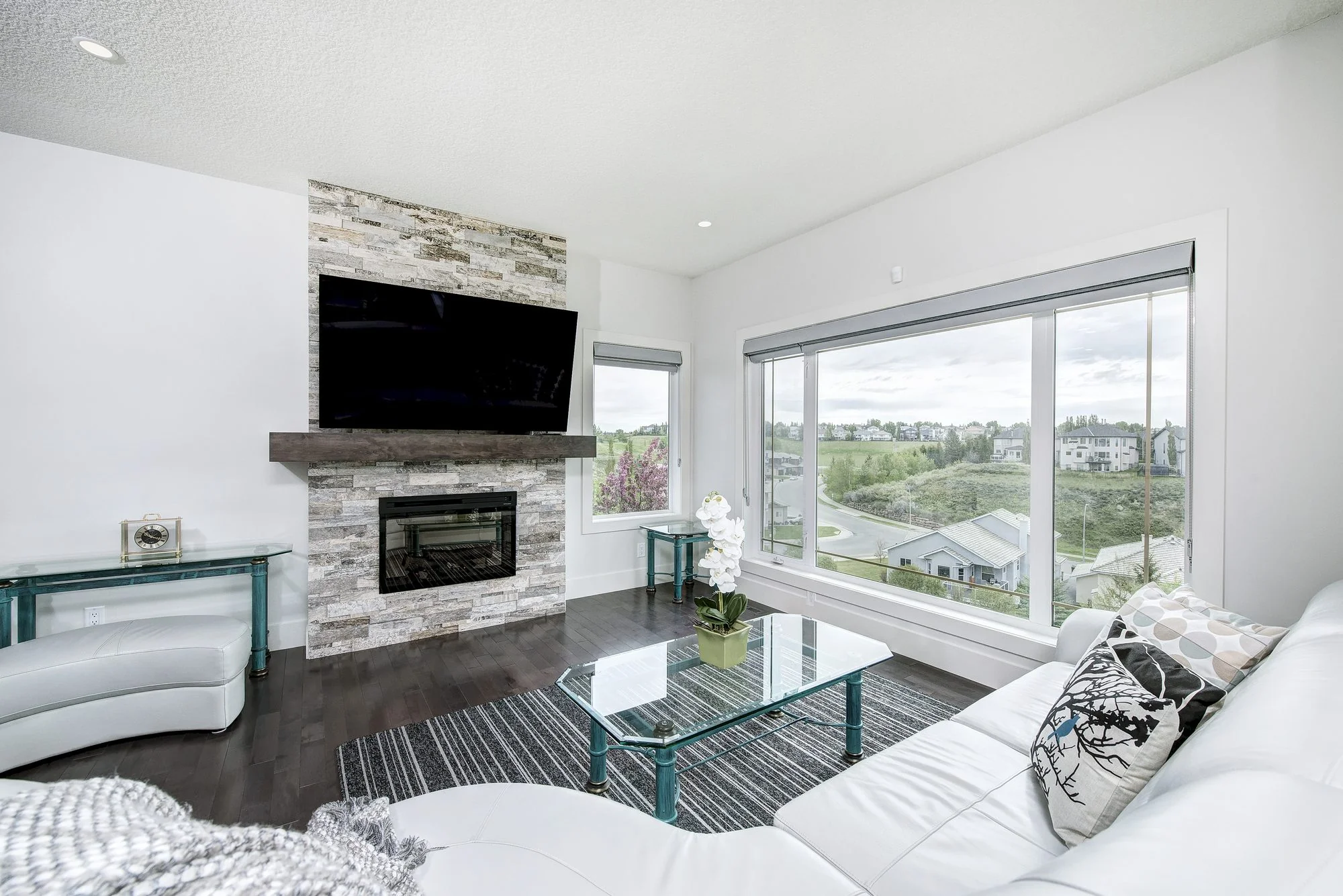 Bright open living room with full height windows in a Calgary home