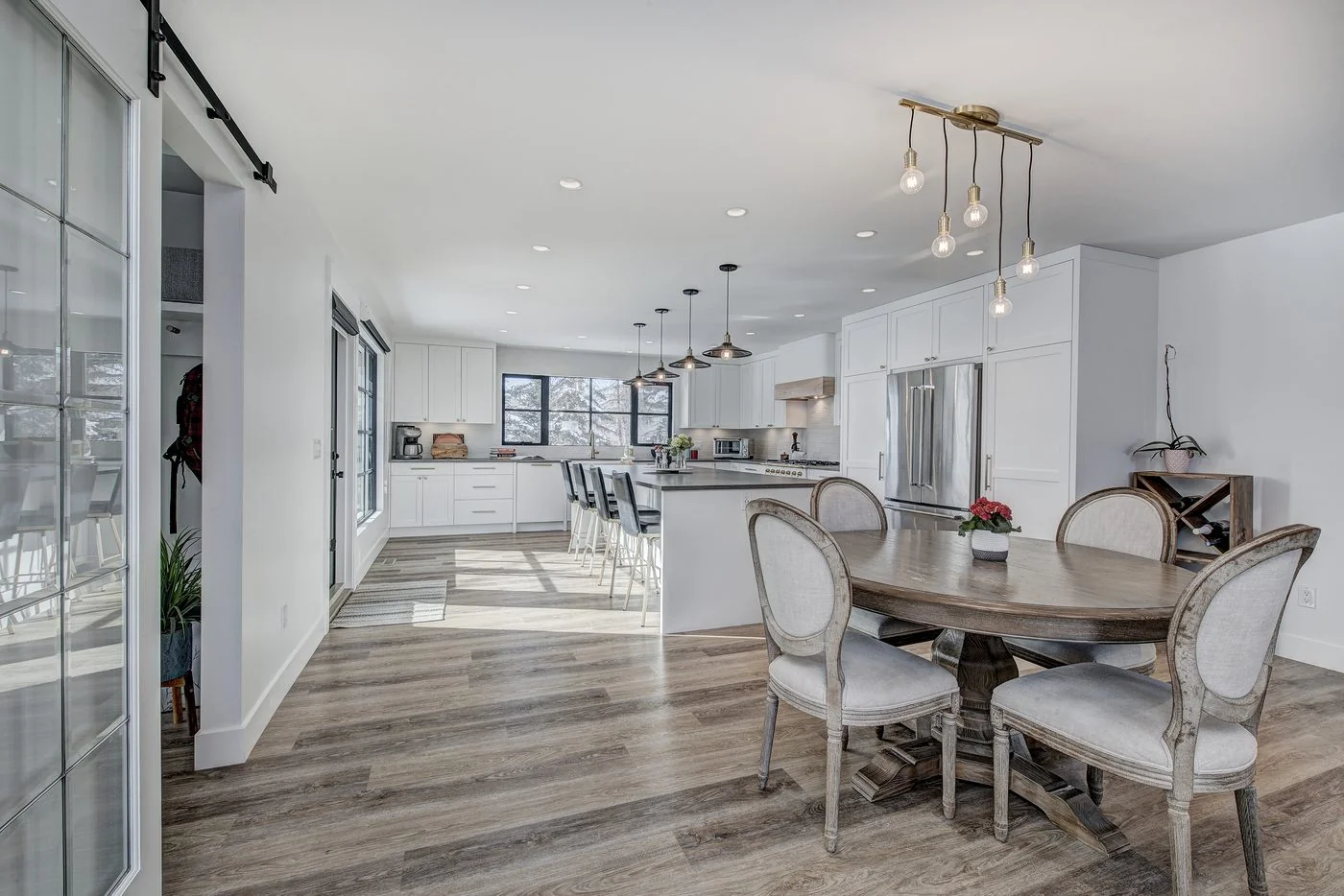 Dining area beside a glass partition in a completed Calgary project