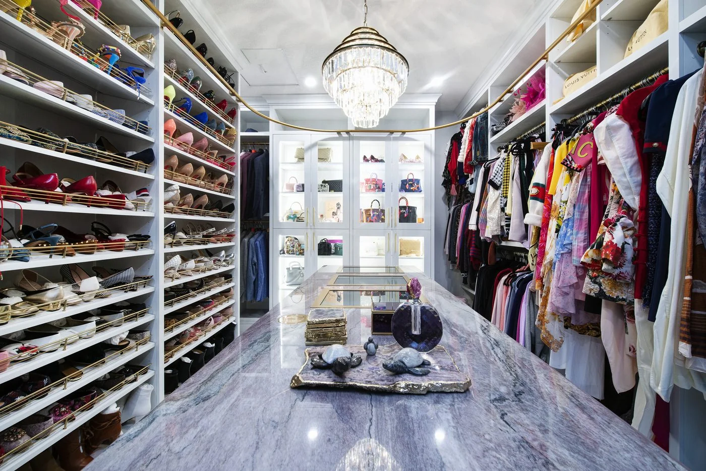 Walk in dressing room with open shelving and a central island