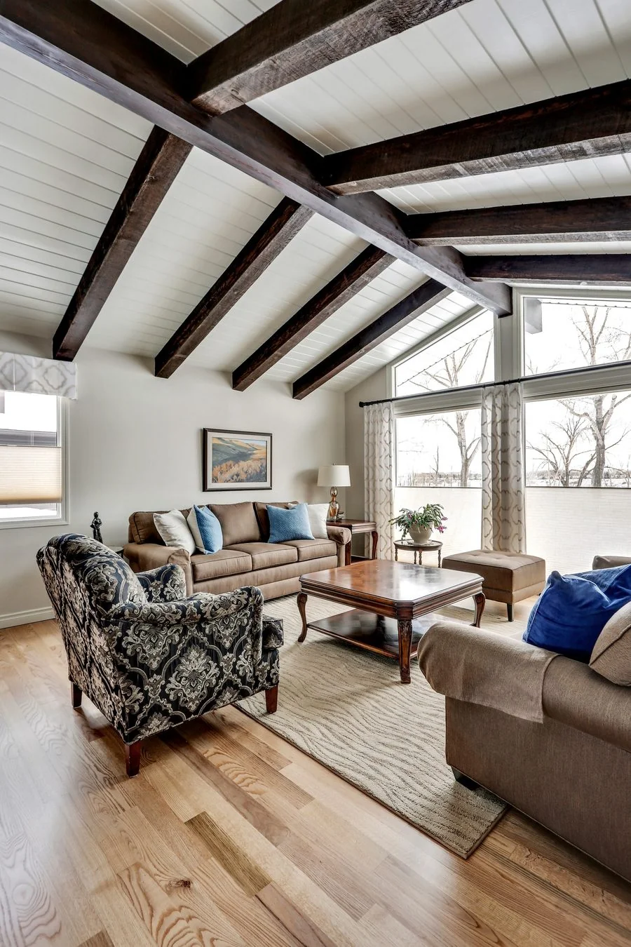 Living room with exposed beams and a vaulted ceiling