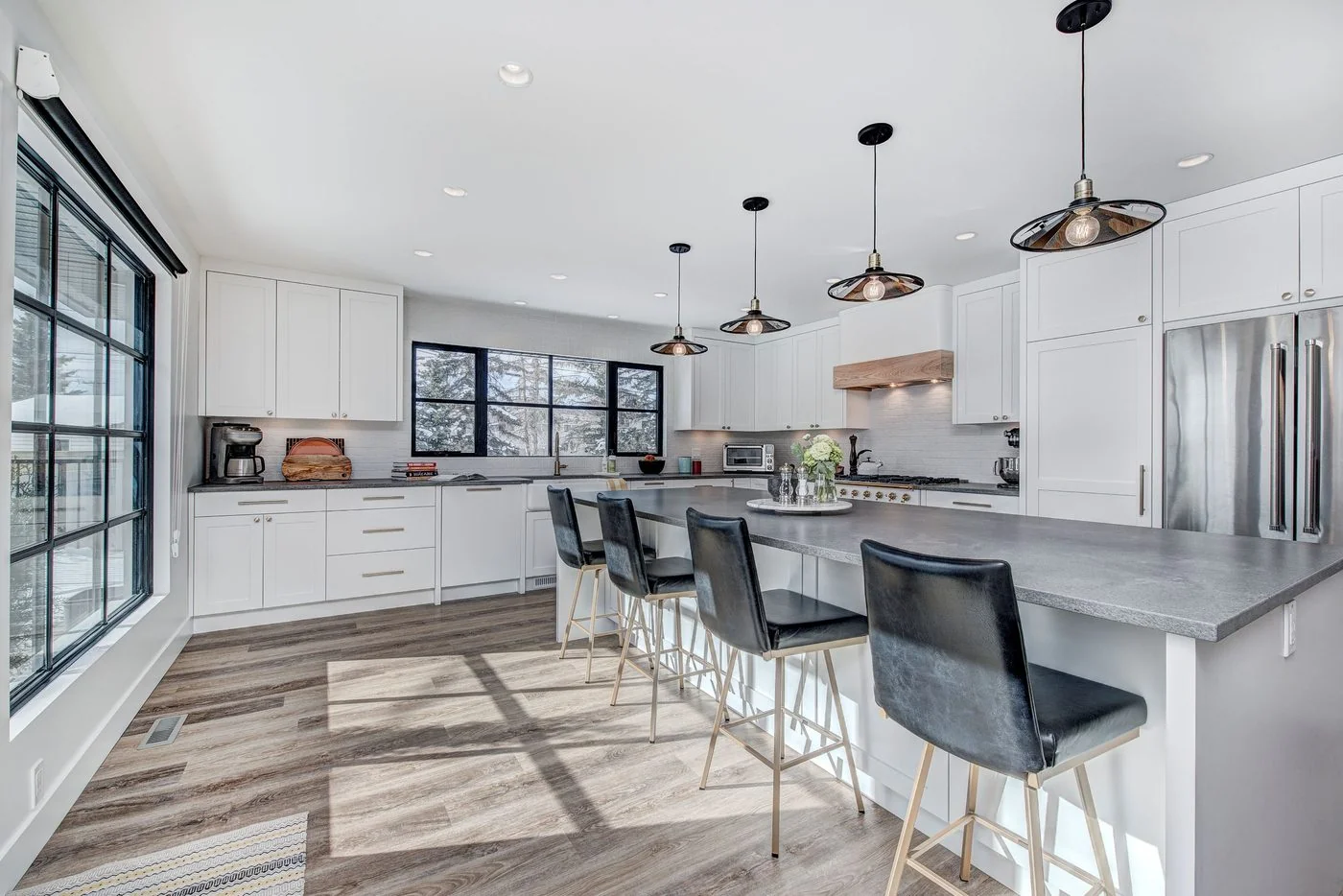Open kitchen with a long island and black framed windows