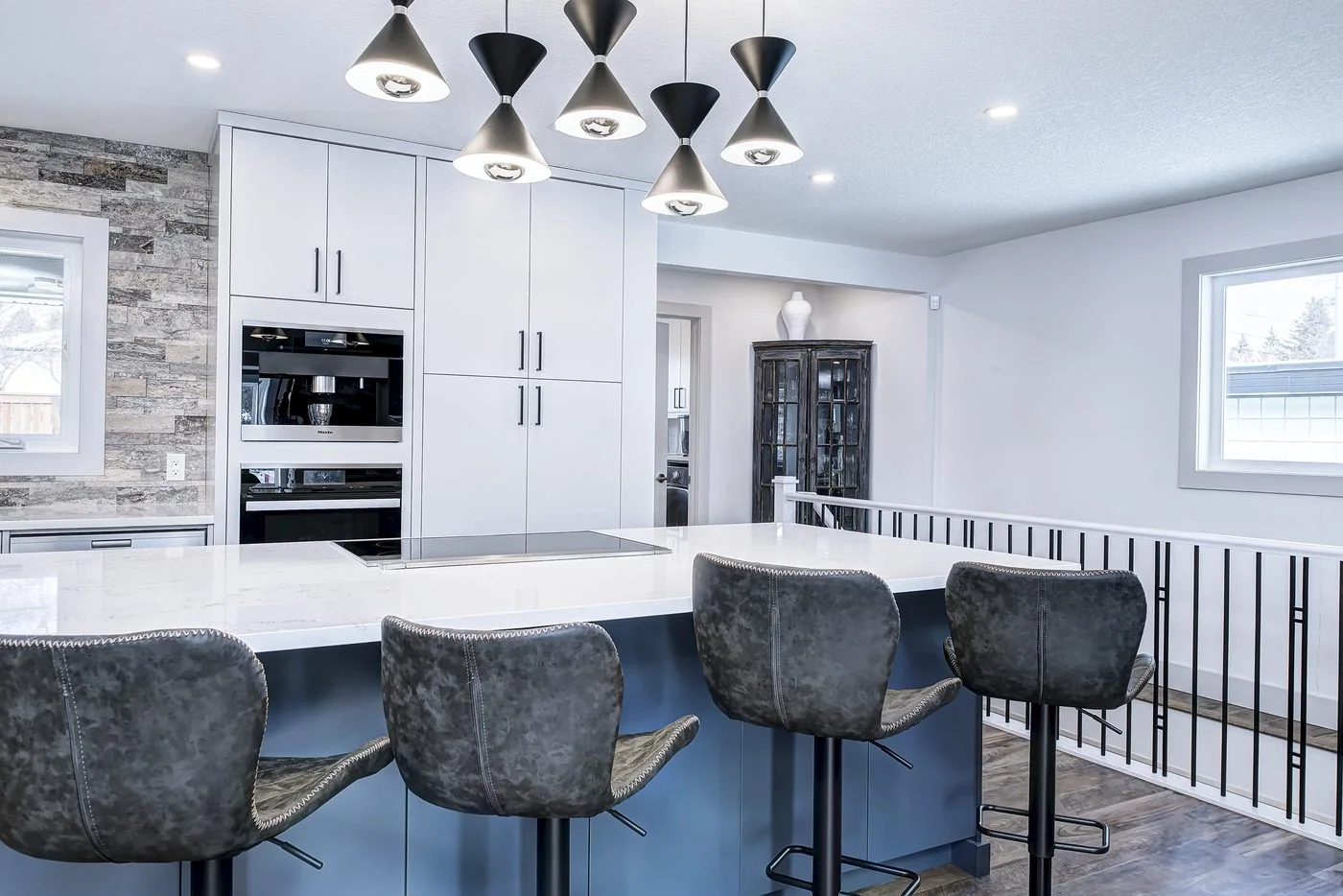 Kitchen island with pendant lighting in a newly built Calgary home