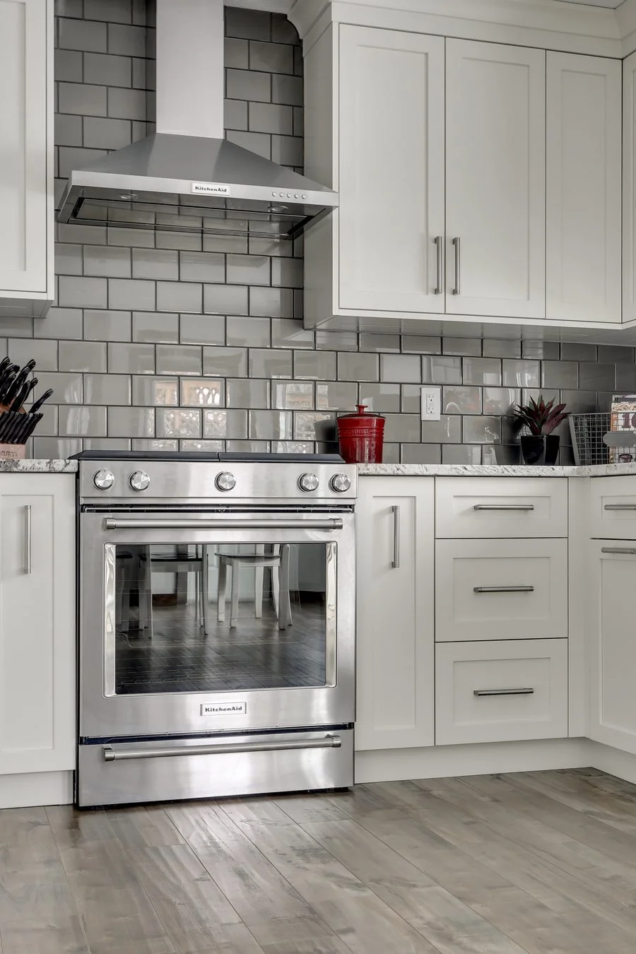 Range and tiled backsplash detail in a Calgary interior design project