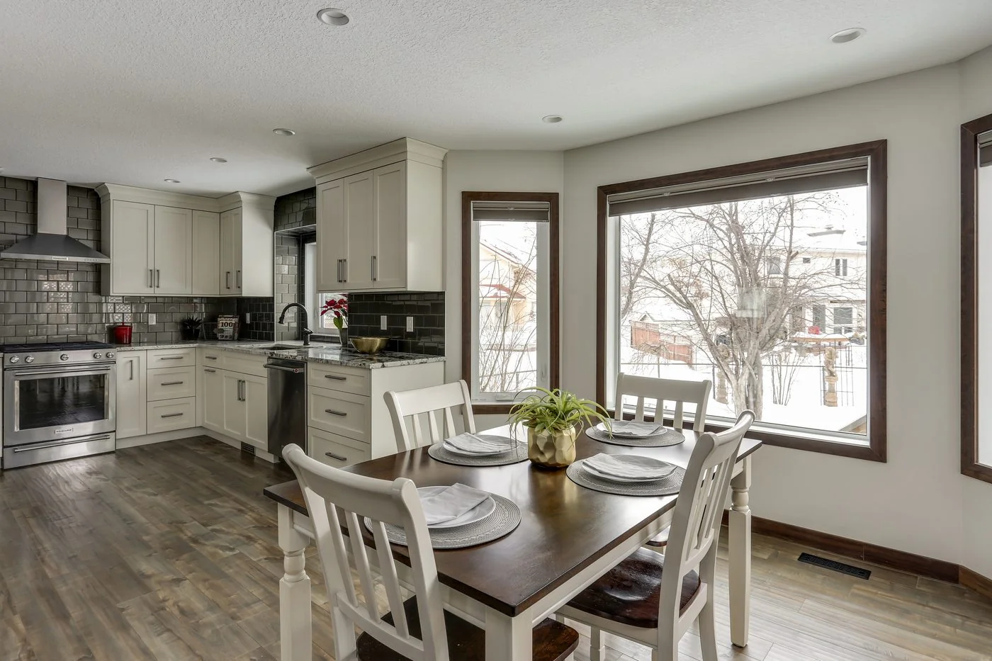Renovated kitchen and dining area with wide plank flooring